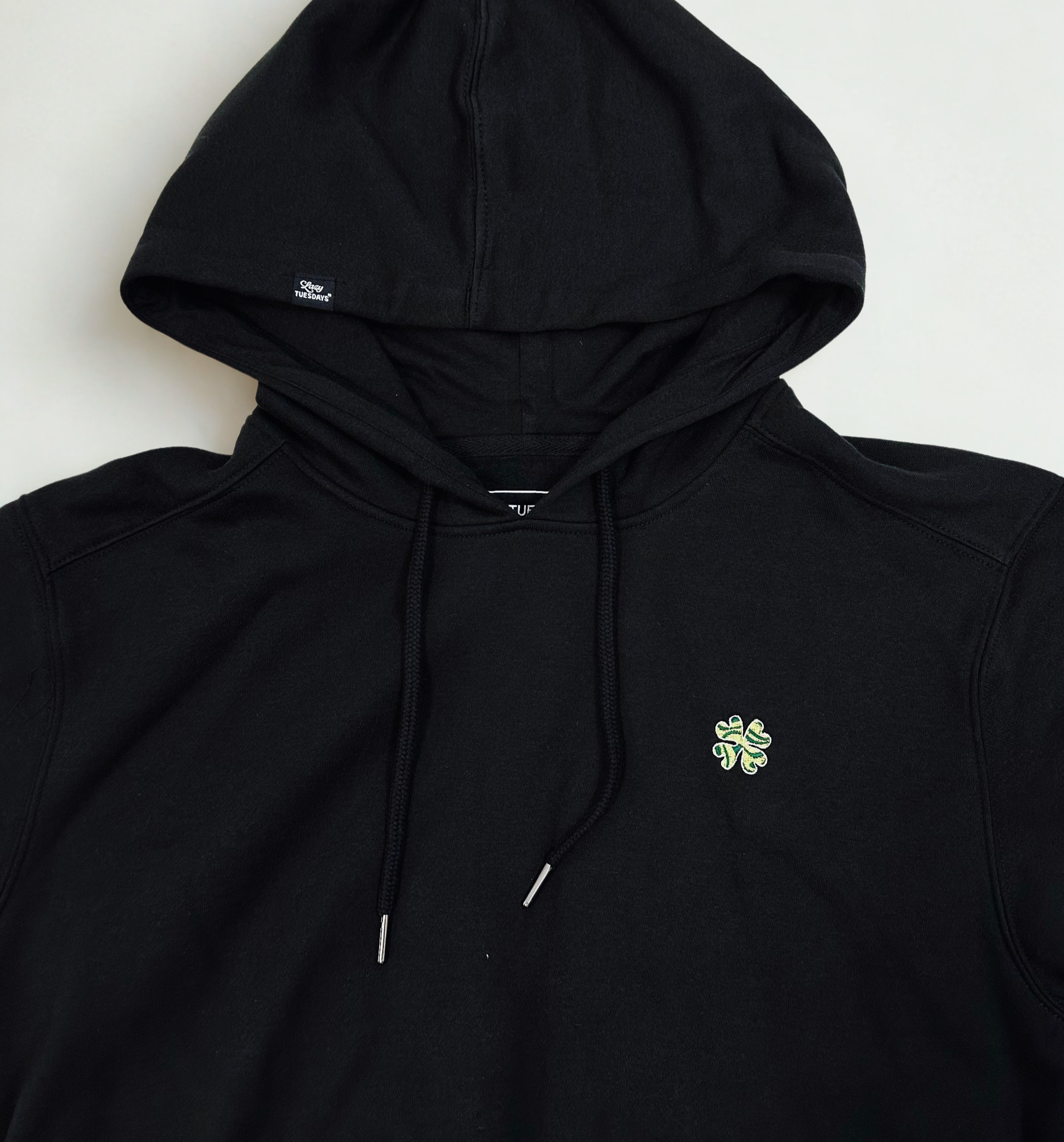 Black Lazy Tuesdays Hoodie with detail shot of embroidery 
