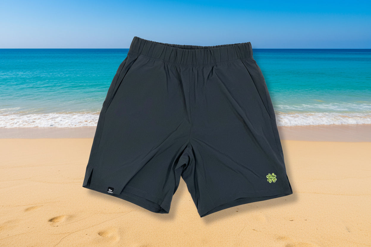 Dark gray shorts with a green logo on a light gray background
